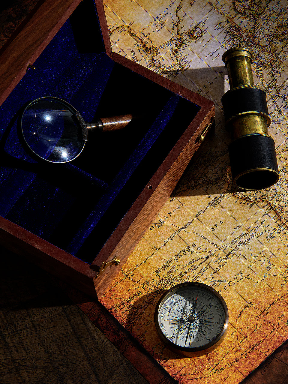 Wooden Box with Antique Telescope, Compass, and Magnifying Glass